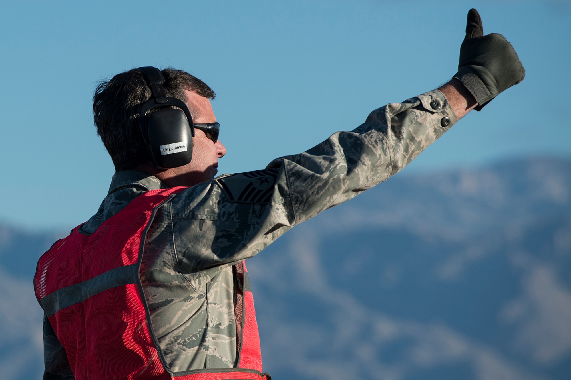 U.S. Air Force Master Sgt. Steve Vance, 307th Aircraft Maintenance Squadron crew chief, give the thumbs after marshaling a B-52H Stratofortress from its parking spot on Feb. 12, 2015, Davis-Monthan Air Force Base, Ariz. Vance is an Air Reserve Technician at Barksdale AFB, La., and is a member of the maintenance crew tasked with regenerating aircraft 61-007, which was decommissioned in 2008 and has spent the last seven years sitting dormant in the 309th Aerospace Maintenance and Regeneration Group's "Boneyard.” (U.S. Air Force photo by Master Sgt. Greg Steele/Released)