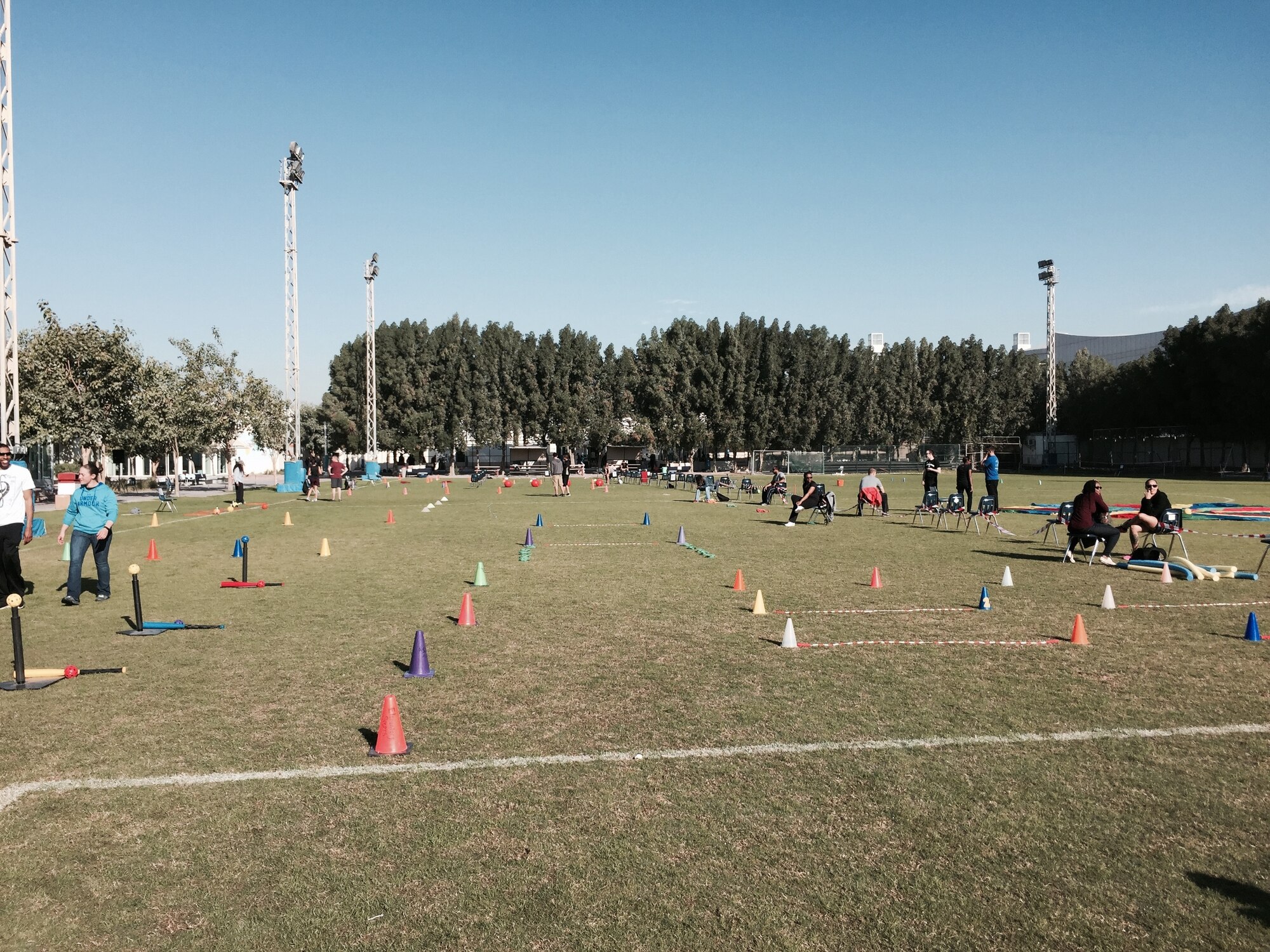Volunteers await the arrival of the students from the American School of Doha for the school's annual National Sport Day, Feb. 10, 2015.  Members from the 437th Operation Group who are currently deployed to Al Udeid Air Base participated in the school's National Sports Day, which is held every year on the second Tuesday in February, and  emphasizes the benefits of physical activity for a healthy lifestyle among its population. Students rotated through activity stations that included three-legged and potato sack races, relay races, throwing and jumping competitions, indoor rock climbing and even water activities. 
