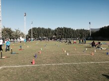 Volunteers await the arrival of the students from the American School of Doha for the school's annual National Sports Day, Feb. 10, 2015. Members from the 437th Operation Group who are currently deployed to Al Udeid Air Base participated in the school's National Sports Day, which is held every year on the second Tuesday in February, and emphasizes the benefits of physical activity for a healthy lifestyle among its population. Students rotated through activity stations that included three-legged and potato sack races, relay races, throwing and jumping competitions, indoor rock climbing and even water activities. (Courtesy photo)