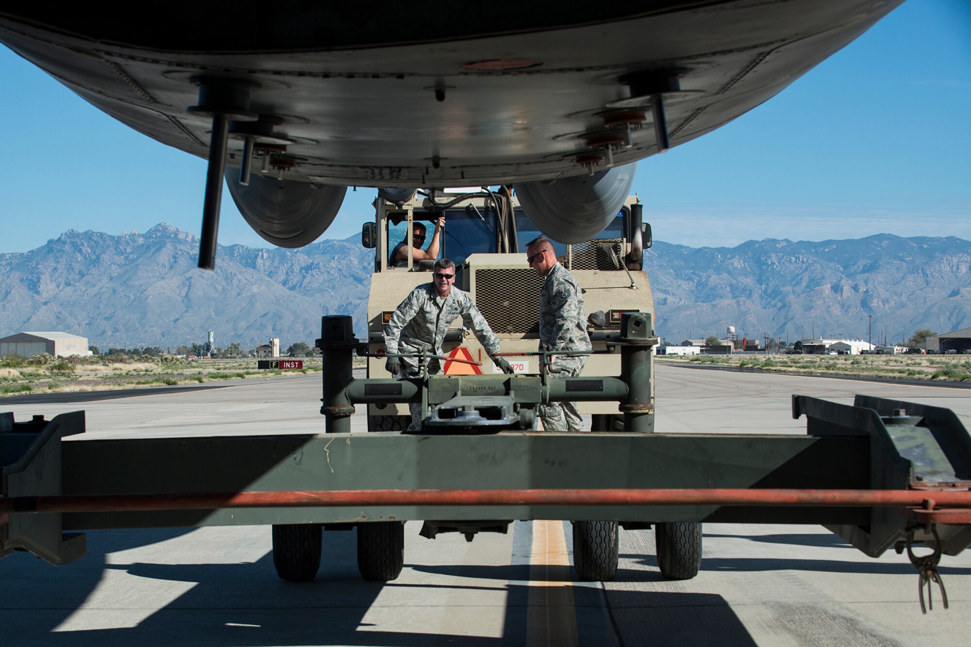 U.S. Air Force Master Sgt. Steve Vance, 307th Aircraft Maintenance Squadron crew chief, and Tech. Sgt. Jonathan Spears, 307th Maintenance Squadron engine specialist, disconnect a tow bar from a B-52H Stratofortress on Feb. 11, 2015, Davis-Monthan Air Force Base, Ariz. The aircraft, tail number 61-007, and known as the "Ghost Rider,” is being regenerated for active service after sitting in storage since 2008 when it was decommissioned and sent the Boneyard. (U.S. Air Force photo by Master Sgt. Greg Steele/Released)