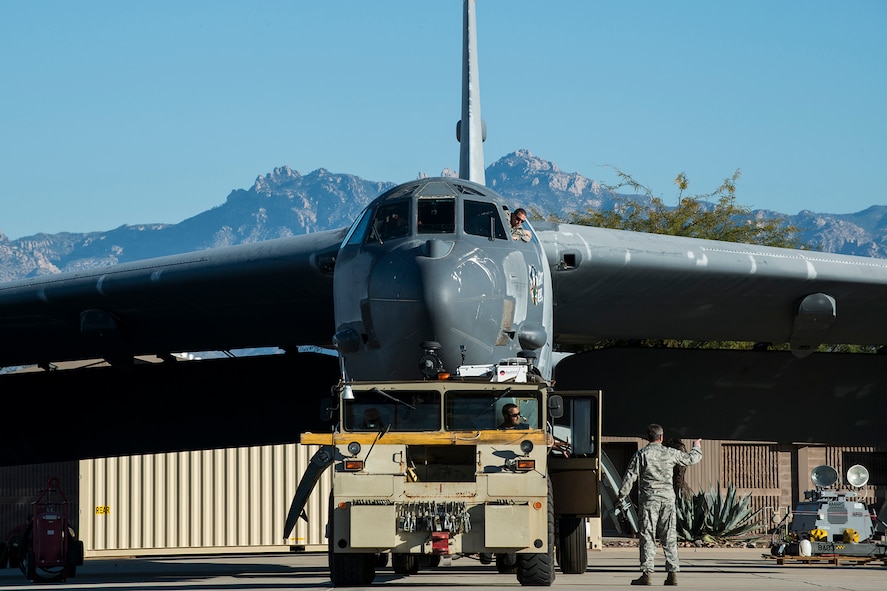A U.S. Air Force B-52 Stratofortress is towed from a maintenance area at the 309th Aerospace Maintenance and Regeneration Group, Feb. 11, 2015, Davis-Monthan Air Force Base, Ariz. The aircraft, tail number 61-1007 and known as the "Ghost Rider,” is being regenerated for active service after sitting in storage since 2008 when it was decommissioned and sent the Boneyard. (U.S. Air Force photo by Master Sgt. Greg Steele/Released)