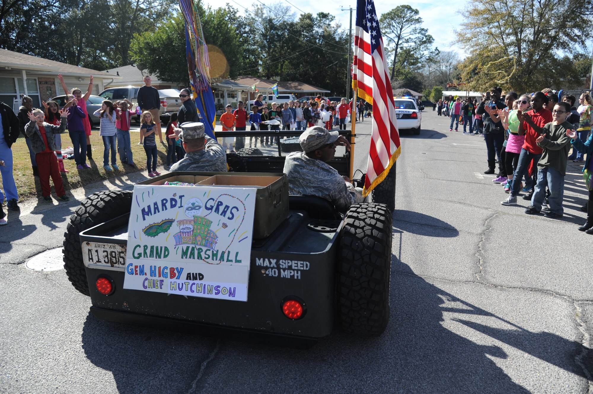 Brig. Gen. Patrick Higby, 81st Training Wing commander, and Chief Master Sgt. Harry Hutchinson, 81st TRW command chief, serve as Grand Marshalls during the Jeff Davis Elementary School Mardi Gras Parade in Biloxi, Miss., Feb. 13, 2015.  The Keesler Honor Guard and other base personnel also participated in the festivities.  (U.S. Air Force photo by Kemberly Groue)