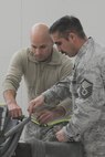 Air Force Reserve Staff Sgt. Derek Saros and Master Sgt. Franco Russo re-assemble the telescoping support on the crew entry door of a C-130H Hercules assigned to the 910th Airlift Wing here, Feb. 7, 2015. Saros and Russo are both assigned to the 910th's Repair and Reclamation shop. U.S. Air Force photo by Tech. Sgt. James Brock