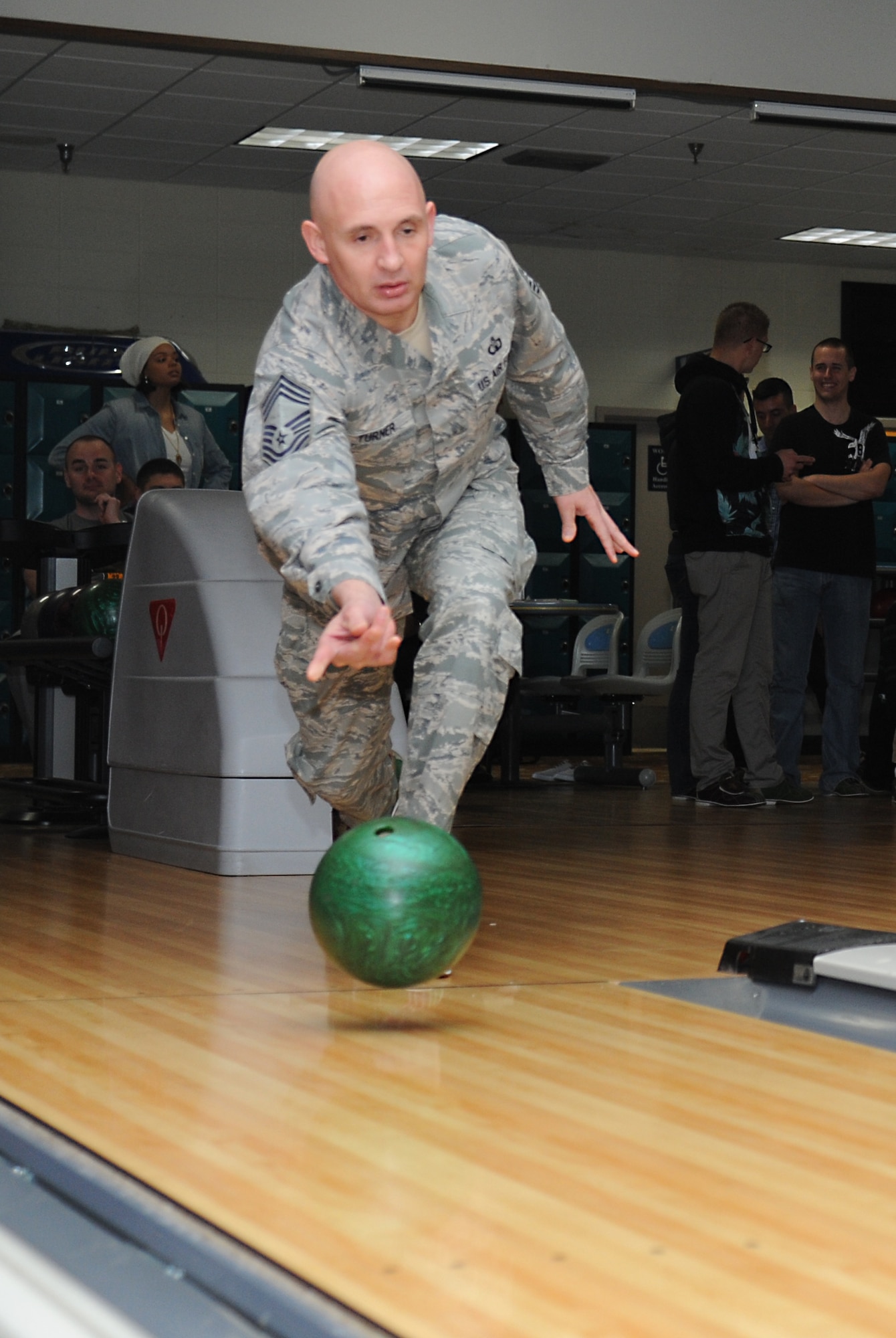 Chief Master Sgt. Johnny Turner, 334th Training Squadron superintendent, tosses his ball down the lane during a bowling tournament Feb. 13, 2015, at Gaudé Bowling Lanes, Keesler Air Force Base, Miss.  The African-American Heritage Committee hosted the event to celebrate Black History Month.  Nineteen teams of five people participated in the tournament.  (U.S. Air Force photo by Kemberly Groue)