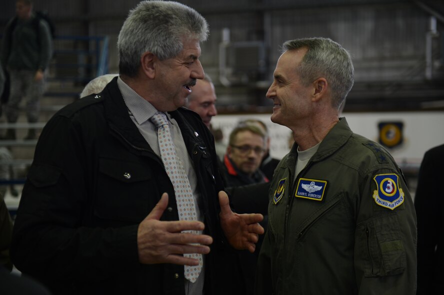U.S. Air Force Lt. Gen. Darryl Roberson, 3rd Air Force and 17th Expeditionary Air Force commander, interacts with Klaus Rodens, mayor of Spangdahlem, during a theater security package announcement at Spangdahlem Air Base, Germany, Feb. 18, 2015. During the announcement, Roberson spoke about the importance of the host nation relationship and the local community to the TSP rotational deployments. (U.S. Air Force photo by Senior Airman Gustavo Castillo/Released) 