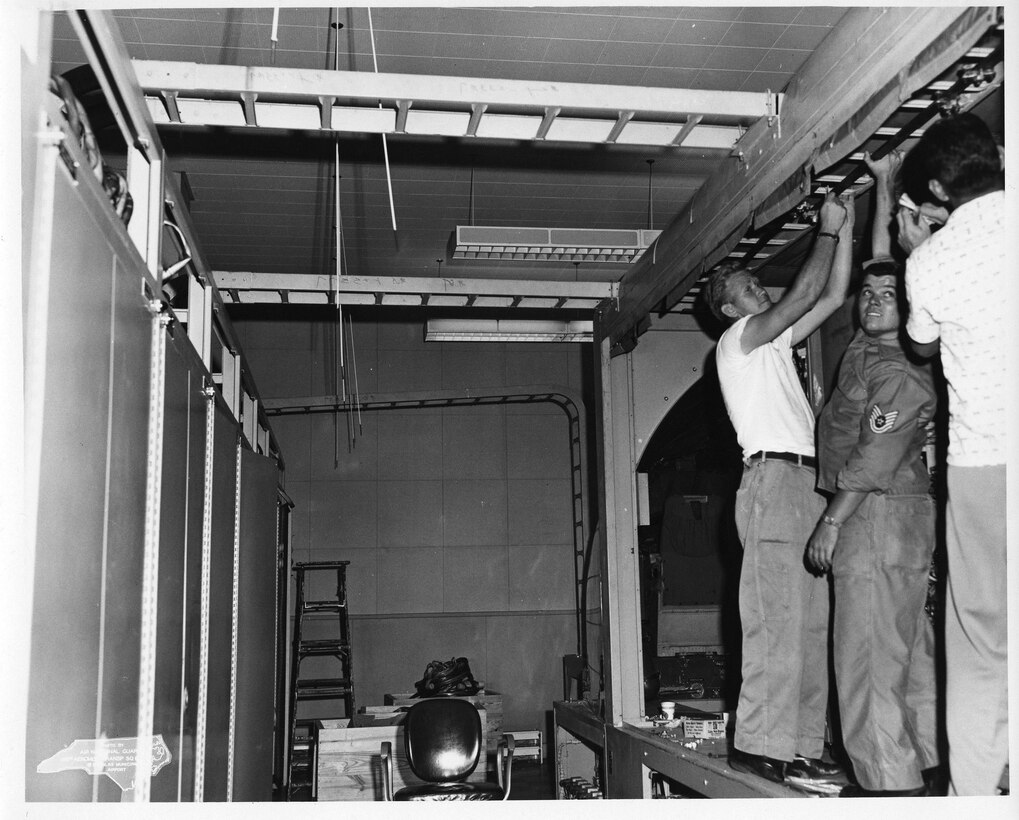 C-121 01 Jun 1962 - 06 Apr 1967 Simulator Installation; Left to Right, #1 Odell Beatty, #2 Coy Fowler, #3 (Back to Camera) Unknown (Photo by NCANG Heritage Program)