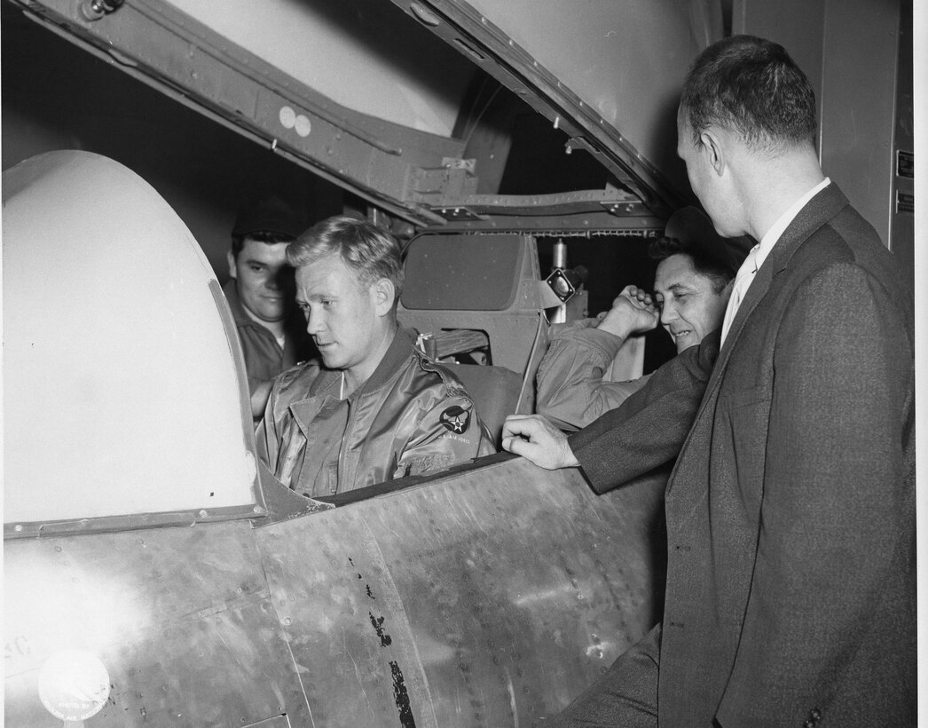 The F-86 was flown from 17 Jan 1954 - 30 Mar 1961:  Simulator staff from Left to Right are: #1 Coy Fowler, #2 Odell Beaty in cockpit, #3 Bill Fish, #4 Howard Ballard (Photo by NCANG Heritage Program)