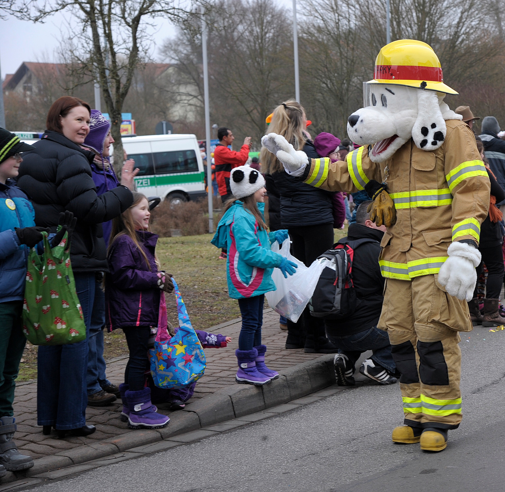 Sparky the Fire Dog waves to the crowd during the Fasching parade in Ramstein-Miesenbach, Germany, Feb. 17, 2015. Firefighters from the 86th Civil Engineer Squadron and approximately 1,400 other participants marched in the parade for more than two hours entertaining and interacting with the local crowd. (U.S. Air Force photo/Senior Airman Timothy Moore)