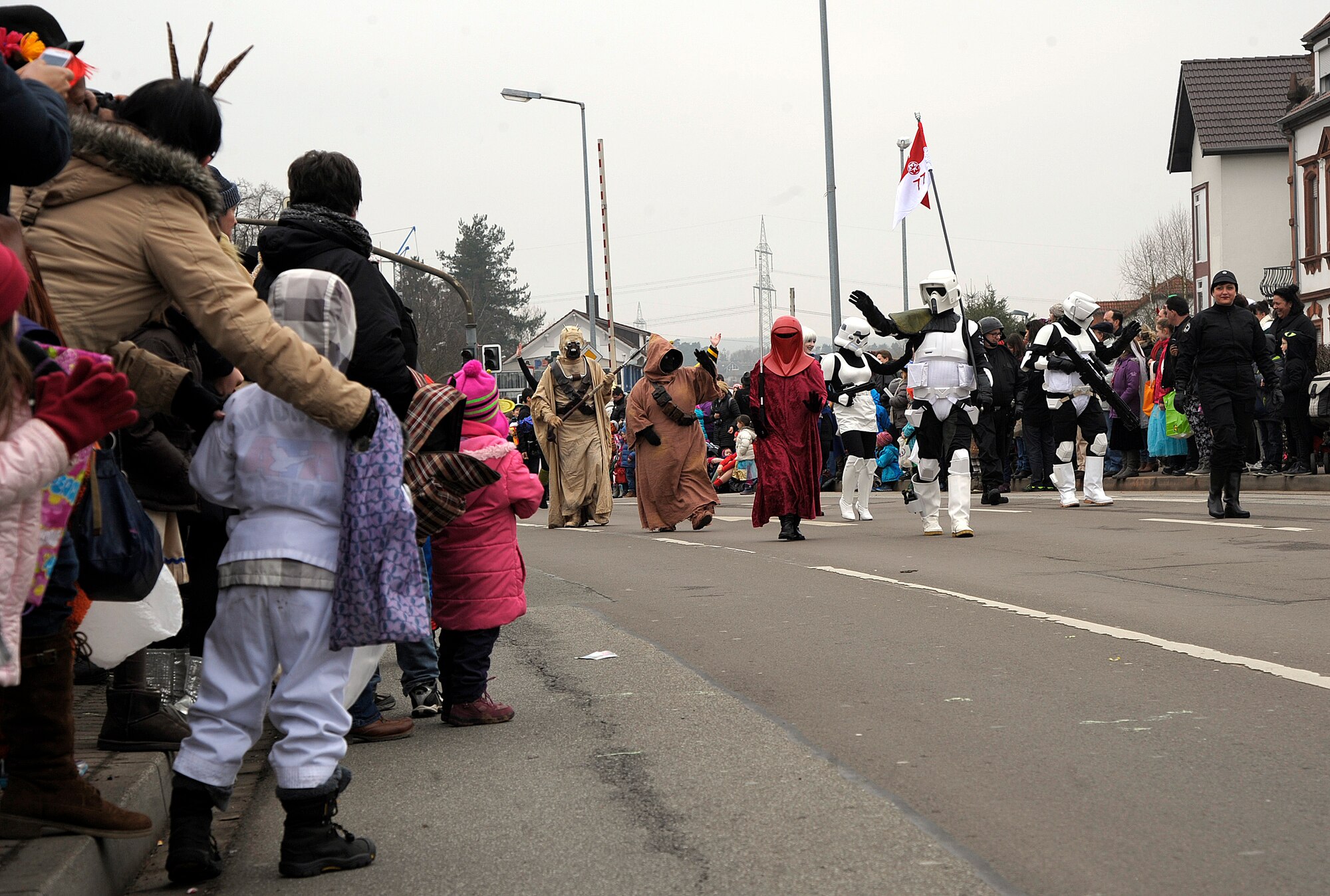 Crowd members look on as participants walk down the street as part of the Fasching parade in Ramstein-Miesenbach, Germany, Feb. 17, 2015. More than 1,400 participants, many of whom were in costume, marched or drove in the parade for more than two hours entertaining the local crowd. (U.S. Air Force photo/Senior Airman Timothy Moore)