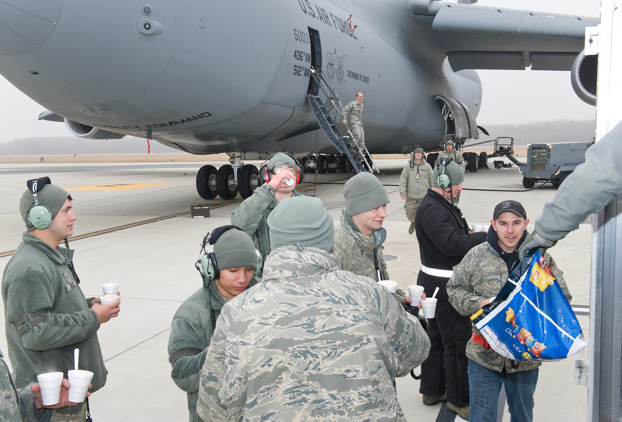 C-5M Super Galaxy maintainers take a break to grab a cup of hot cocoa, chili, cornbread, cookies and other food items during Operation Cocoa and Chili Feb. 9, 2015, on Dover Air Force Base, Del. The Dover Chief's Group made numerous stops on the flight line and other facilities on the base passing out cups of cocoa, homemade chili and other food items to Team Dover members. (U.S. Air Force photo/Roland Balik)