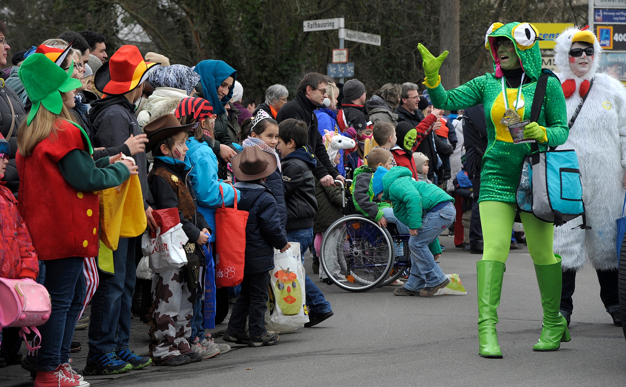 A parade participant gives treats to the crowd during the Fasching parade in Ramstein-Miesenbach, Germany, Feb. 17, 2015. More than 1,400 participants joined in the 64th annual parade. (U.S. Air Force photo/Senior Airman Timothy Moore)