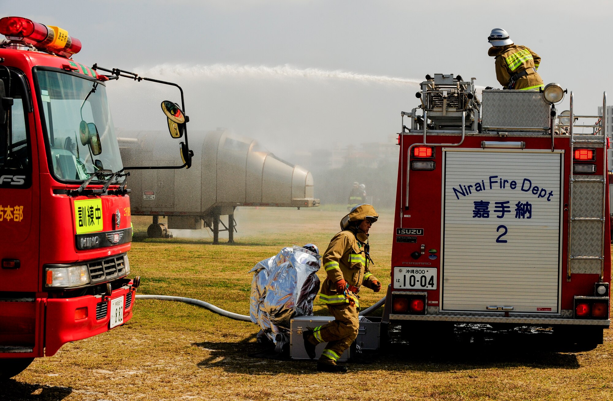 Nirai Fire Department firefighters douse a controlled fire from a simulated aircraft fuselage on Torii Station, Japan, Feb. 17, 2015. The firefighters participated in an annual bilateral aircraft mishap exercise with local and military emergency response agencies to improve their life-saving skills through training. (U.S. Air Force photo by Airman 1st Class John Linzmeier)
