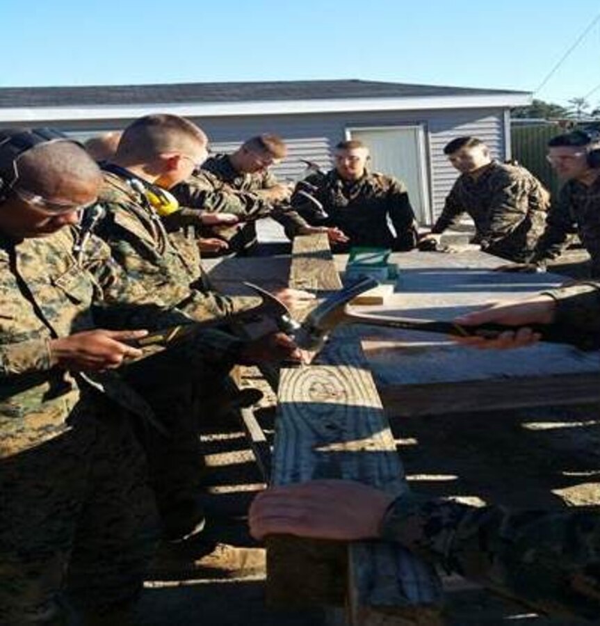 Marines of BCE 11-15 learn nailing technique.