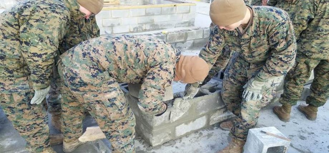 Marines of BCE 11-15 learn how to work with concrete block.