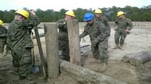 Marines of BCE 13-15 work on log crib construction.