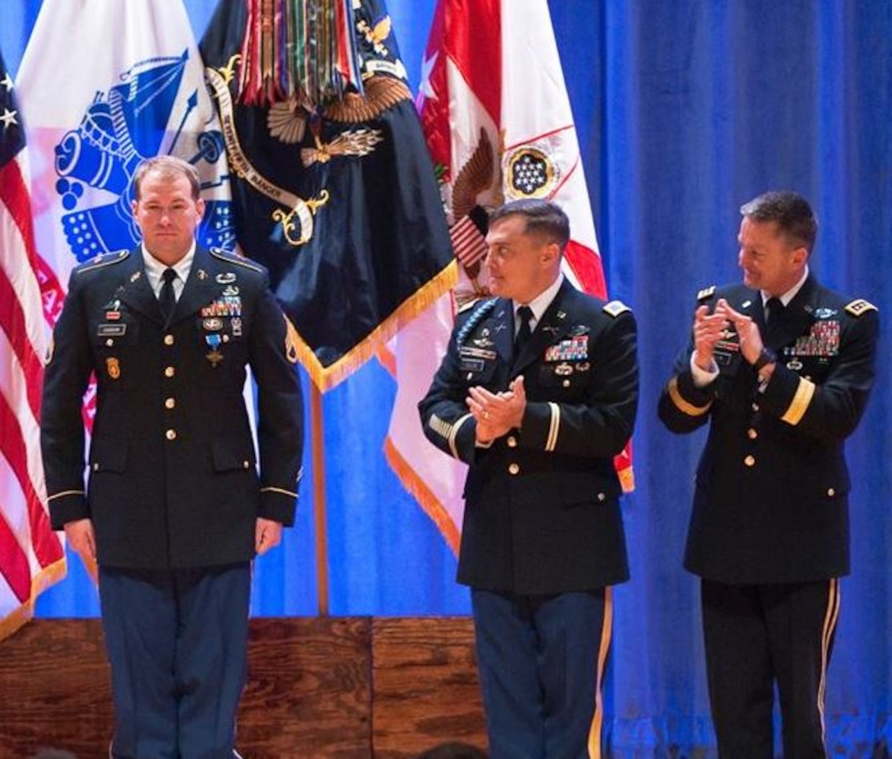 Army Col. Patrick Ellis, center, commander of the 3rd Battalion, 75th Ranger Regiment, and U.S. Army Vice Chief of Staff Gen. Daniel B. Allyn applaud Army Staff Sgt. Jeffery M. Dawson after he received the Distinguished Service Cross during a ceremony at Fort Benning, Georgia, Feb. 17, 2015. U.S. Army photo by Patrick A. Albright
