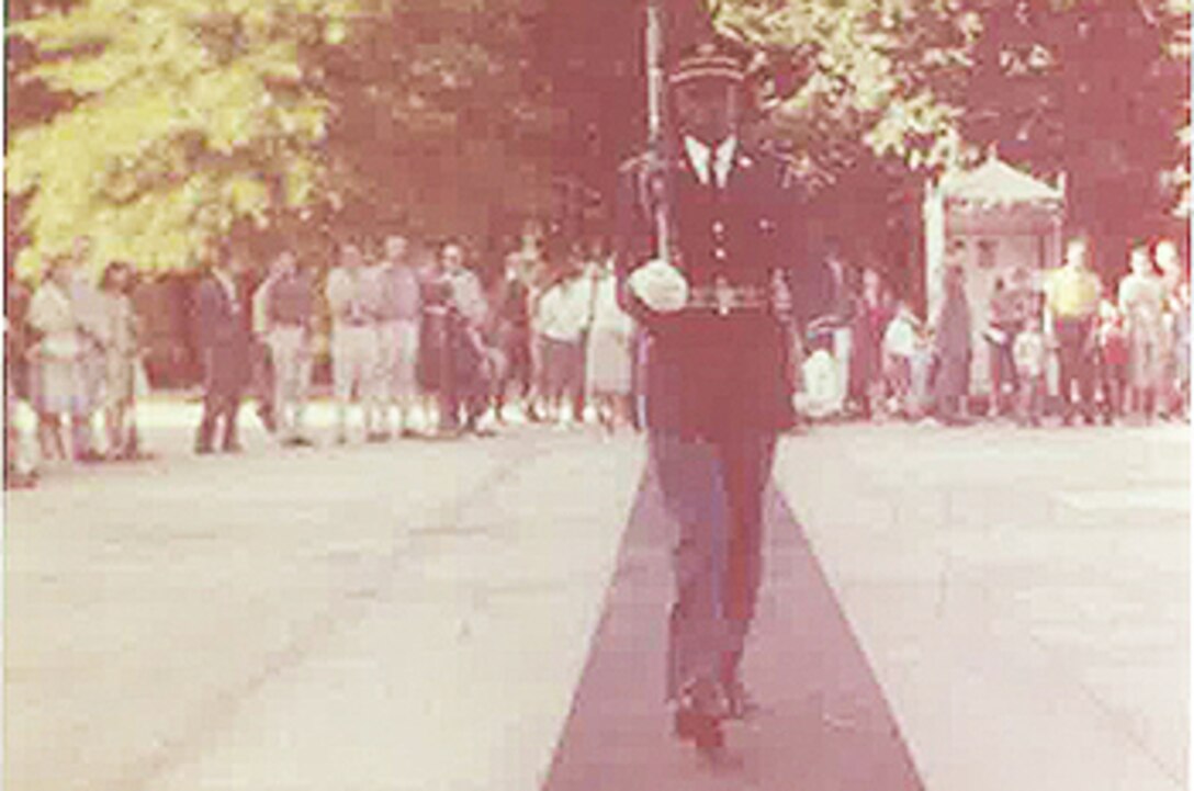 The first African American soldier on duty at the Tomb of the Unknown Soldier, then-Spc. 4th Class Fred Moore, walks his relief in 1961 at Arlington National Cemetery in Virginia. Moore, who was described by other members of his relief as a “straight trooper,” didn’t realize the importance of his post until an article was published in a 1961 issue of Ebony magazine, highlighting the cultural and historical significance. Photo courtesy of Fred Moore