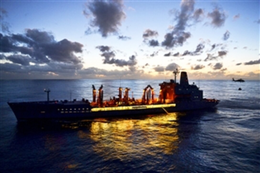 The Military Sealift Command fleet replenishment oiler USNS Guadalupe delivers supplies to the amphibious assault ship USS Makin Island during a nighttime vertical replenishment in the Pacific Ocean, Feb.12, 2015. The Makin Island is returning to homeport in San Diego from a seven-month deployment to the western Pacific and U.S. Central Command areas of responsibility. 