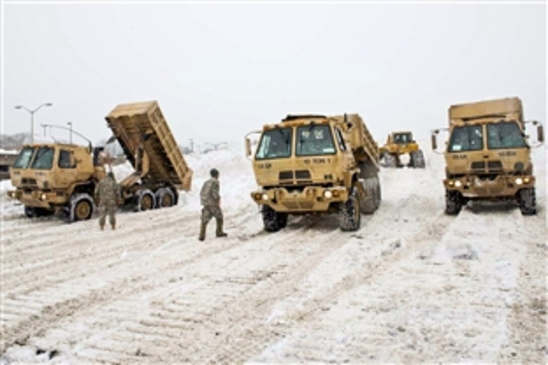 National Guardsmen help remove snow in Braintree, Mass., Feb. 17, 2015. The guardsmen are assigned to the Vermont Army National Guard's Detachment 1, 131st Engineer Company. Vermont and Maine Guardsmen are supporting their Massachusetts counterparts as they respond to recent major snowfalls that have buried areas of the state.