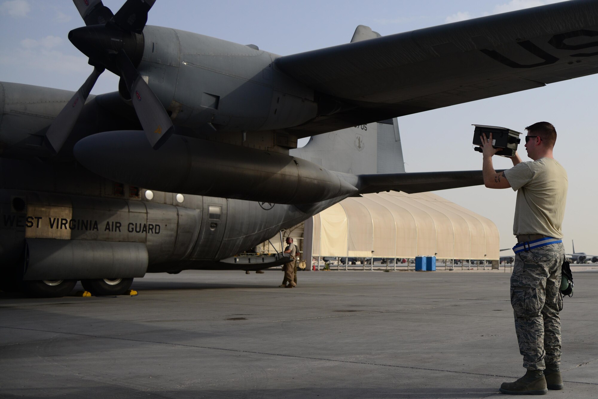 U.S. Air Force Senior Airman Isaac Fields, 746th Expeditionary Aircraft Maintenance Unit avionics, performs an Identification, Friend-or-Foe check on a C-130 Hercules, Feb. 18, 2015, at Al Udeid Air Base, Qatar. IFF is an identification system designed for command and control that enables military and national interrogation systems to identify aircraft, vehicles or forces as friendly and to determine their bearing and range from the interrogator. (U.S. Air Force photo by Senior Airman Kia Atkins)