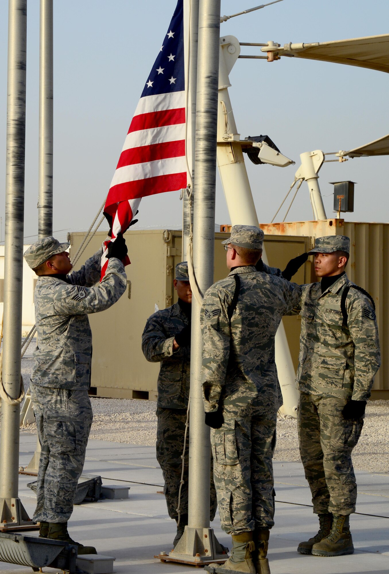 U.S. Air Force Airmen from the 379th Air Expeditionary Wing Honor Guard lower the American flag during a Washington’s Birthday retreat ceremony, Feb. 16, 2015, at Al Udeid Air Base, Qatar. Washington’s Birthday, also known as President’s day, was originally celebrated on February 22 but moved to the third Monday of February in an effort to celebrate a more generalized recognition of Presidential achievements. (U.S. Air Force photo by Senior Airman Kia Atkins)