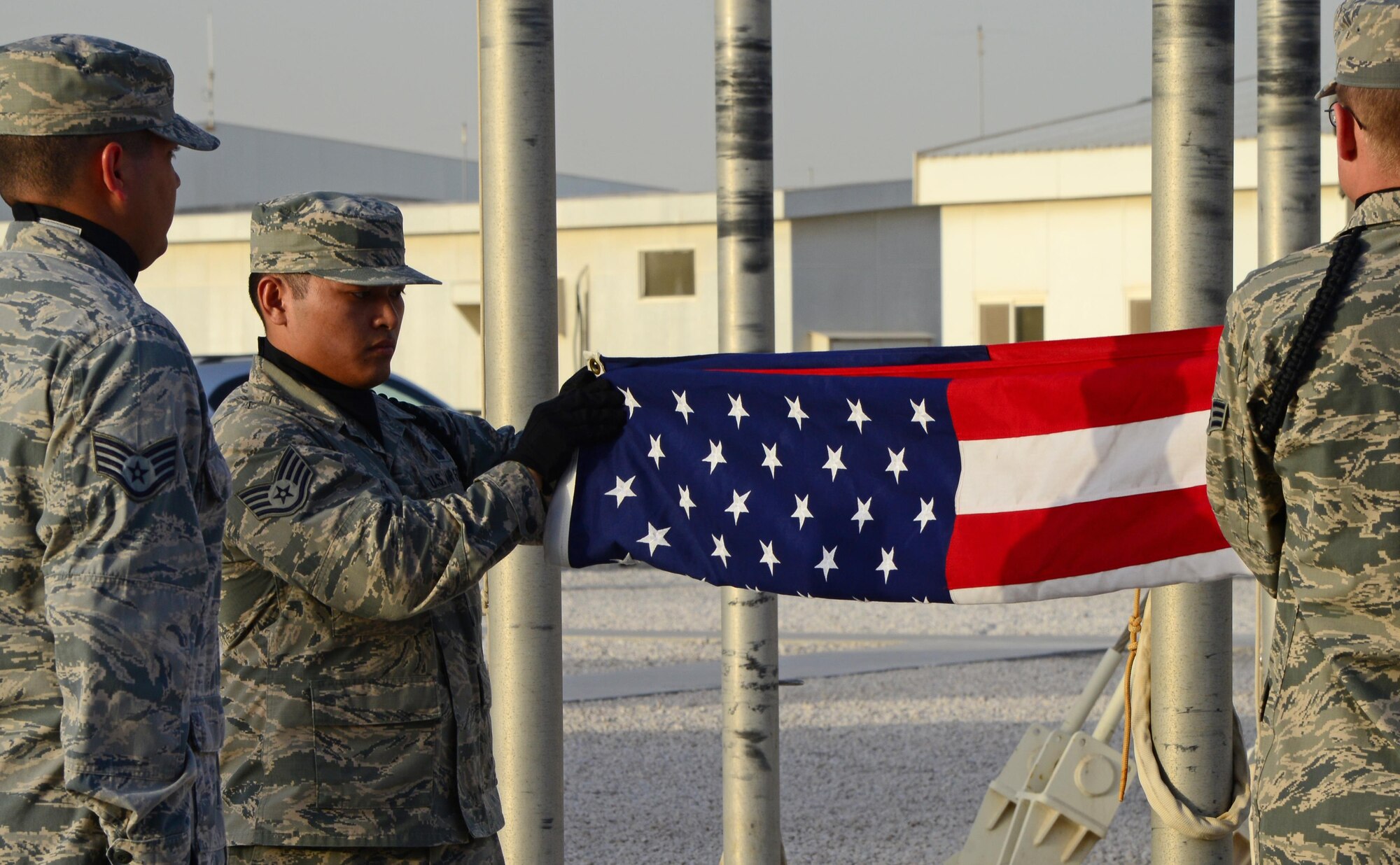 U.S. Air Force Airmen from the 379th Air Expeditionary Wing Honor Guard lower the American flag during a Washington’s Birthday retreat ceremony, Feb. 16, 2015, at Al Udeid Air Base, Qatar. Washington’s Birthday, also known as President’s Day, was the first individual American whose life was officially celebrated with a holiday. (U.S. Air Force photo by Senior Airman Kia Atkins)