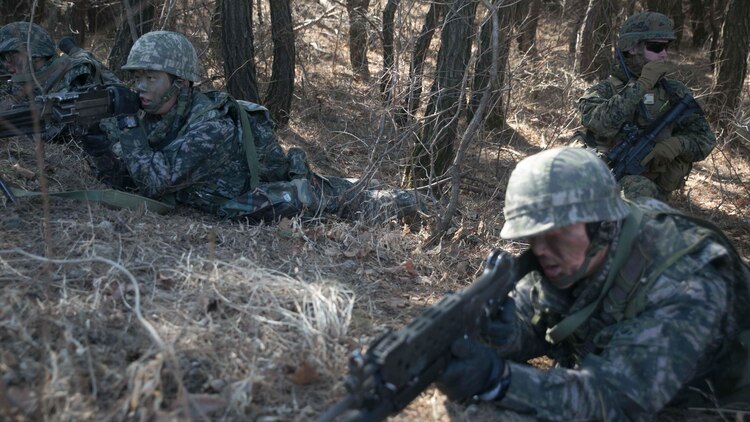 Republic of Korea and U.S. Marines assault enemy defensive positions during Korean Marine Exchange Program 15-17 Feb. 13 at the Cham Sae Mi Close-Quarters Battle Training Facility in Pohang, Republic of Korea. The overarching goal of KMEP is to enhance and improve the interoperability of ROK and U.S. Marine Corps forces. The ROK Marines are with Company 6, 32nd Battalion, 1st ROK Marine Division. The U.S. Marines are with Company K, 3rd Battalion, 3rd Marine Regiment, currently assigned to 4th Marine Regiment, 3rd Marine Division, III Marine Expeditionary Force under the unit deployment program. 