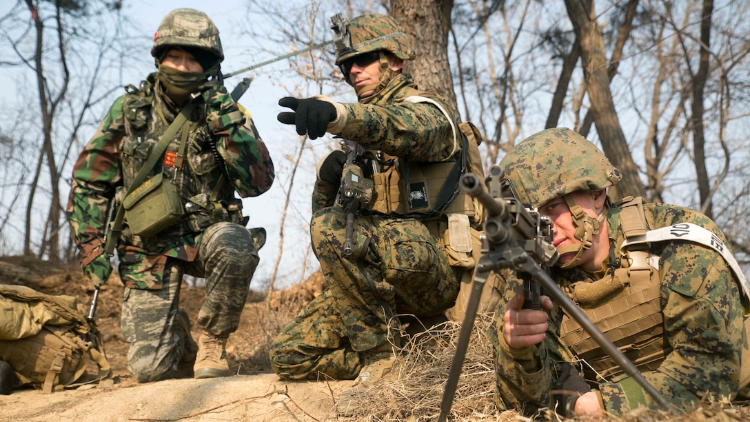U.S. Marine 1st Lt. Taylor L. Paul, center, points out an enemy position as Republic of Korea Marine Cpl. Lee Jun Yeob, left, reports it over the radio during Korean Marine Exchange Program 15-17 Feb. 10 at the Cham Sae Mi Close-Quarters Battle Training Facility in Pohang, Republic of Korea. KMEP 15-17 is a regularly-scheduled, bilateral, small-unit training exercise, which enhances the combat readiness and interoperability of ROK and U.S. Marine Corps forces. Paul, from Noel, Missouri, is a platoon commander with Company I, 3rd Battalion, 3rd Marine Regiment, currently assigned to 4th Marine Regiment, 3rd Marine Division, III Marine Expeditionary Force under the unit deployment program. Lee, from Pusan, ROK, is a field radio operator with Company 5, 32nd Battalion, 1st ROK Marine Division. 
