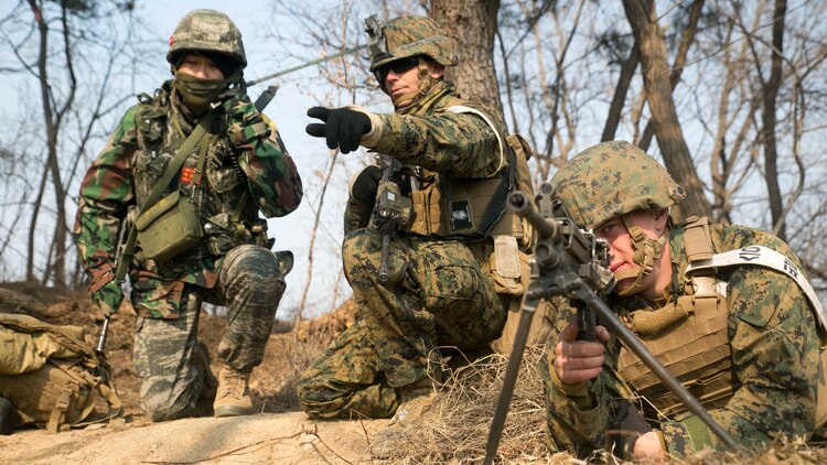 U.S. Marine 1st Lt. Taylor L. Paul, center, points out an enemy position as Republic of Korea Marine Cpl. Lee Jun Yeob, left, reports it over the radio during Korean Marine Exchange Program 15-17 Feb. 10 at the Cham Sae Mi Close-Quarters Battle Training Facility in Pohang, Republic of Korea. KMEP 15-17 is a regularly-scheduled, bilateral, small-unit training exercise, which enhances the combat readiness and interoperability of ROK and U.S. Marine Corps forces. Paul, from Noel, Missouri, is a platoon commander with Company I, 3rd Battalion, 3rd Marine Regiment, currently assigned to 4th Marine Regiment, 3rd Marine Division, III Marine Expeditionary Force under the unit deployment program. Lee, from Pusan, ROK, is a field radio operator with Company 5, 32nd Battalion, 1st ROK Marine Division. 