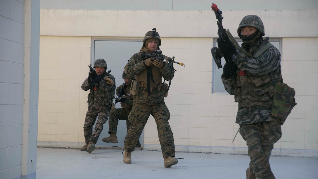 Republic of Korea and U.S. Marines clear a building during Korean Marine Exchange Program 15-17 Feb. 9 at the Cham Sae Mi Close-Quarters Battle Training Facility in Pohang, Republic of Korea. KMEP 15-17 is a regularly-scheduled, bilateral, small-unit training exercise, which enhances the combat readiness and interoperability of ROK and U.S. Marine Corps forces. The ROK Marines are with Company 5, 32nd Battalion, 1st ROK Marine Division. The U.S. Marines are with Company I, 3rd Battalion, 3rd Marine Regiment, currently assigned to 4th Marine Regiment, 3rd Marine Division, III Marine Expeditionary Force under the unit deployment program.