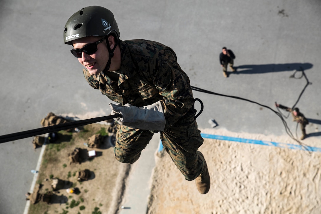 Cpl. Logan A. Hancock hangs from a rope while executing a skid rappel Feb. 11 on Camp Hansen, Okinawa, Japan during the helicopter rope suspension training course. HRST is a course that trains Marines on the necessary skills required to perform a wide variety of rappelling techniques they may need to use in a combat operation. The skid rappel is a rappel that offers no other surface contact besides the rope itself. Hancock, an Albemarle, North Carolina native, is a reconnaissance man with Force Reconnaissance Company, 3rd Reconnaissance Battalion, 3rd Marine Division, III Marine Expeditionary Force. 