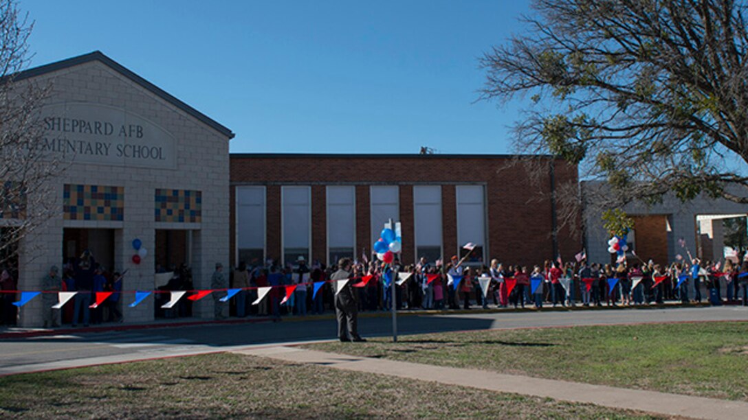 Survivors from the battle of Iwo Jim are greetied by students as they arrive at Sheppard Air Force Base Elementary School for the 70th Anniversary Iwo Jima Veteran's Program performed by students of the school at Sheppard Air Force Base, Texas, February 13, 2015. Survivors enjoyed special songs performed by the Sheppard Choir and poems written and recited by sixth grade students.