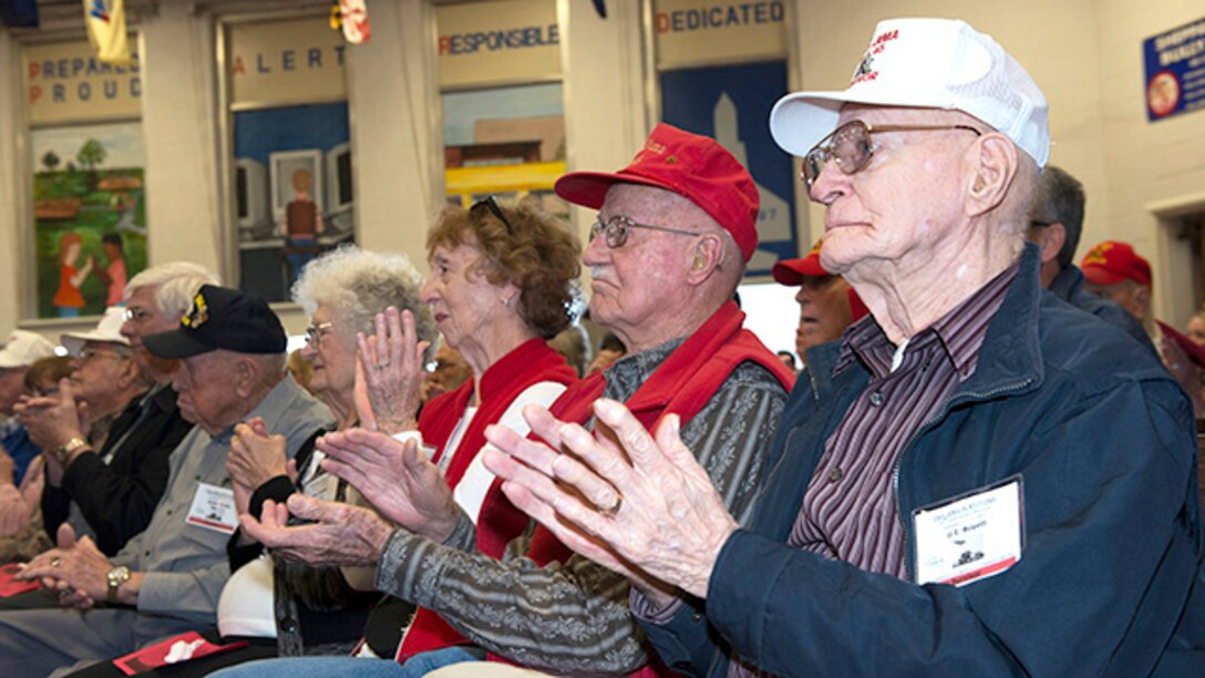 Survivors from the battle of Iwo Jima applaud after a song performed by the students of the Sheppard Choir at Sheppard Air Force Base Elementary School during the 70th Anniversary Iwo Jima Veteran's Program at Sheppard Air Force Base, Texas, February 13, 2015. The survivors enjoyed special songs and poems written and recited by sixth grade students.