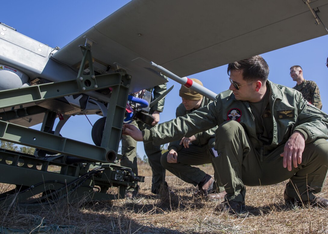 Capt. Eric Eastman, left, and Capt. Jonathan C. Putney, center, unmanned aircraft system officers with Marine Unmanned Aerial Vehicle Squadron 2, Marine Aircraft Group 14, 2nd Marine Aircraft Wing inspect every detail of the RQ-7B Shadow unmanned aerial vehicle, from the engine to the wheels, in preparation for launch aboard Hurlburt Field, Eglin Air Force Base, Florida, Feb. 5, 2015. VMU-2 flew the Shadow UAV as part of a training exercise and to provide aerial support to of U.S. Marine Corps Forces Special Operations Command training in the surrounding area. Using the Shadow, the VMU-2 team is able to relay communications between units, provide reconnaissance and surveillance, as well as laser guide aerial or ground attacks on the objective. (U.S. Marine Corps photo by Lance Corporal Olivia McDonald/Released)