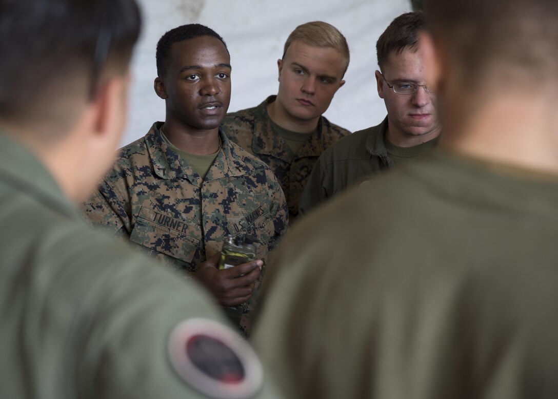 Pfc. Dameon N. Turner, a field radio operator with Marine Unmanned Aerial Vehicle Squadron 2, Marine Aircraft Group 14, 2nd Marine Aircraft Wing, teaches an informal class to the aviation mechanics responsible for connecting radios to the RQ-7B Shadow unmanned aerial vehicle about radio operations aboard Hurlburt Field, Eglin Air Force Base, Florida, Feb. 7, 2015. VMU-2 flew the Shadow UAV as part of a training exercise and to provide aerial support to of U.S. Marine Corps Forces Special Operations Command training in the surrounding area. Using the Shadow, the VMU-2 team is able to relay communications between units, provide reconnaissance and surveillance, as well as laser guide aerial or ground attacks on the objective. (U.S. Marine Corps photo by Lance Corporal Olivia McDonald/Released)