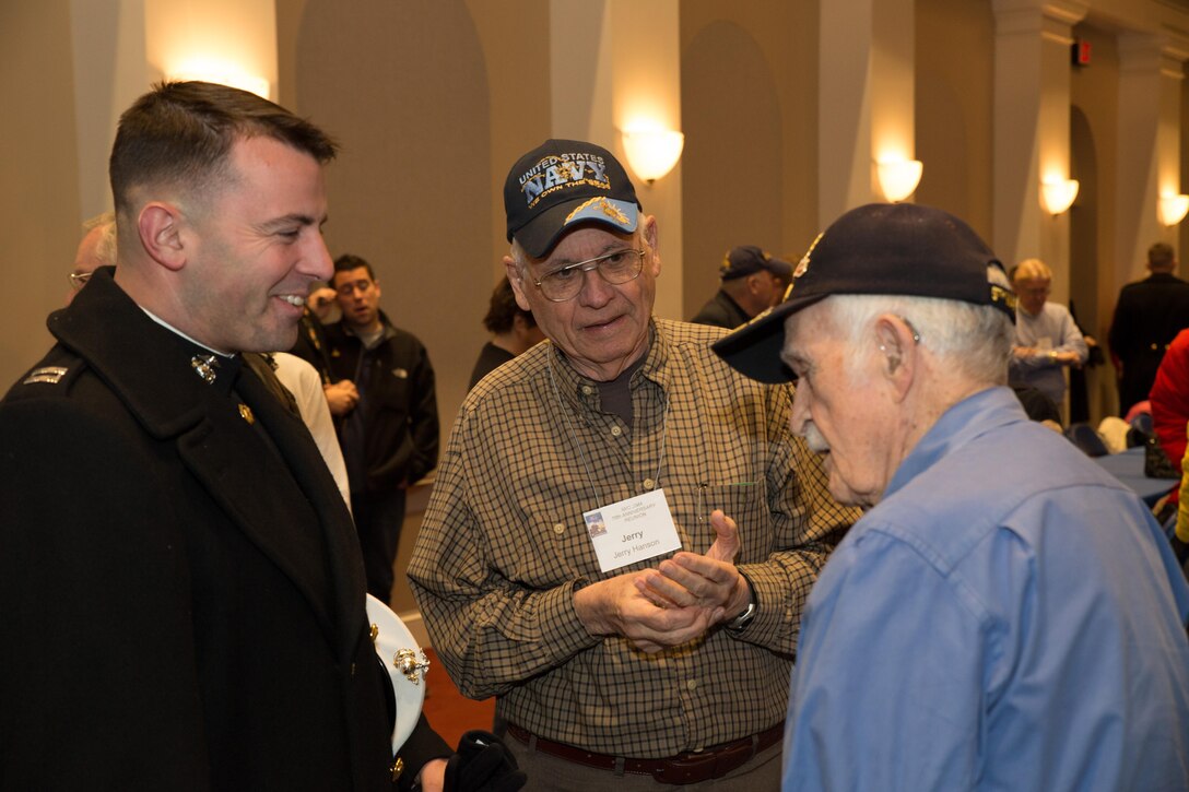 Capt. William Pendergast, a logistics officer at Marine Barracks Washington, D.C., speaks with Iwo Jima Veterans during a ceremony for 70th Anniversary of the landing on Iwo Jima in Crawford Hall, Marine Barracks Washington, D.C. Feb. 19, 2015 (U.S. Marine Corps Photo by Lance Cpl. Christian Varney/Released) 