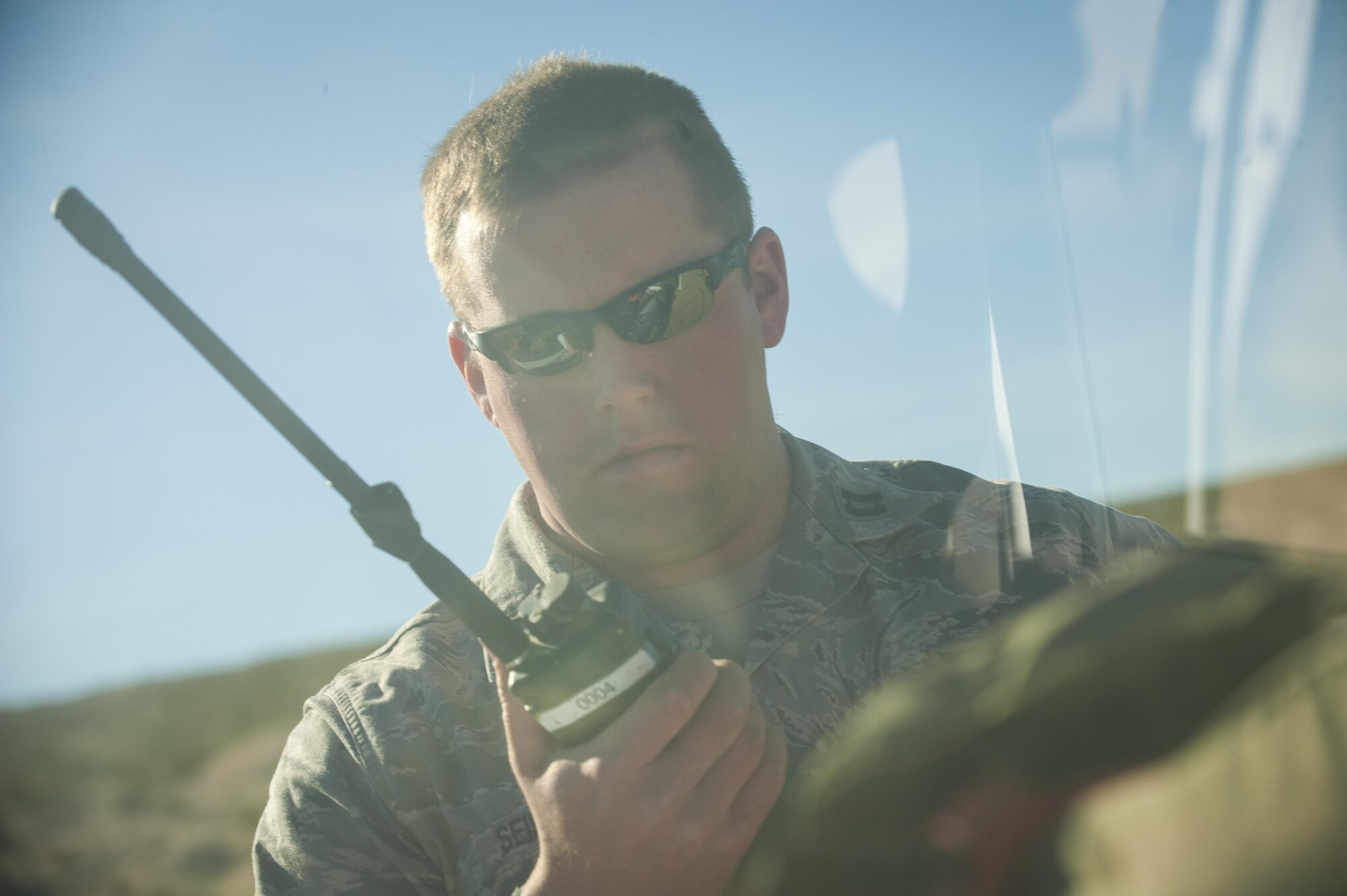 Capt. Bradley Siefert communicates with a B-52 aircrew Feb. 12, 2015, during the Integrated Training Exercise 2-15 on Marine Corps Air Ground Combat Center Twentynine Palms, Calif. Two Minot Air force Base, N.D., B-52 aircrew supported the exercise with close-air support for ground units. Siefert is a pilot with the 69th Bomb Squadron. (U.S. Air Force photo/Airman 1st Class Apryl Hall)