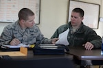 Airman 1st Class Nicholas Sirois and Staff Sgt. Michael Sirois review record documentation while particpating in Sentry Savannah 15-1, Feb. 13, 2015, Savannah, Georgia.  Sentry Savannah 15-1 is the Air National Guard's largest Fighter Integration, Air-to-Air, training exercise encompassing 4th and 5th generation aircraft.