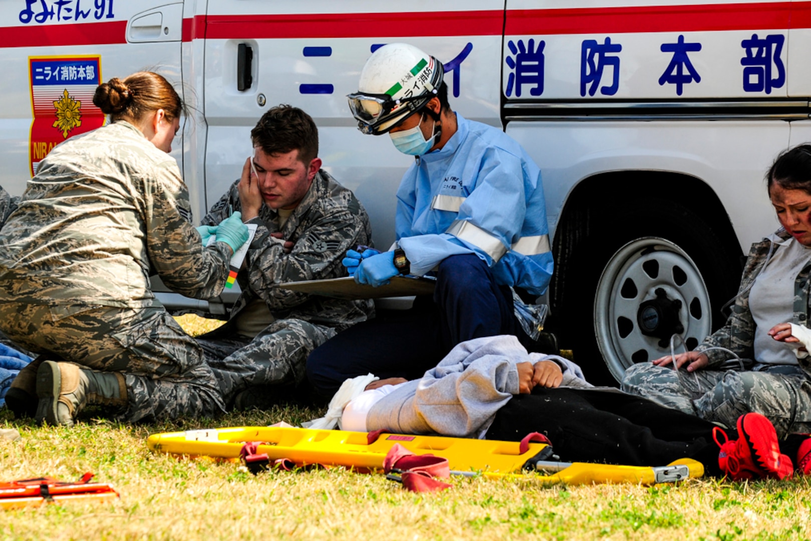 KADENA AIR BASE, Japan  (Feb. 17, 2015 ) – Simulated casualty U.S. Air Force Senior Airman Eric Way, 18th Munitions Squadron munitions journeyman, receives aid from an Okinawa Police Department (OPD) officer during a bilateral training exercise on Torii Station. Personnel from the OPD were the first to respond to a simulated aircraft mishap and were soon joined by Kadena Air Base police officers, firefighters, crash and rescue and emergency management personnel along with other local emergency response agencies. 