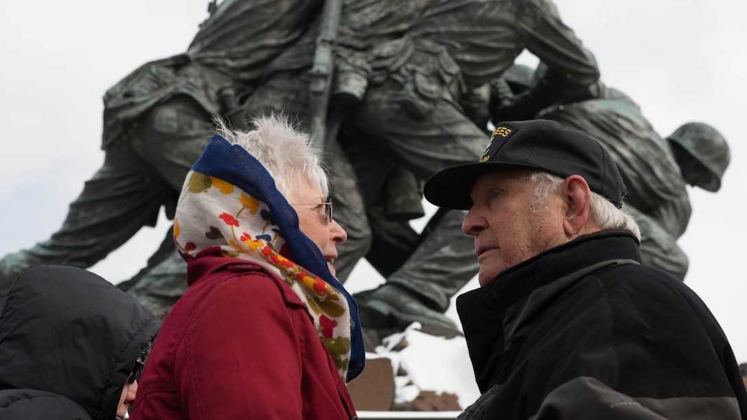Battle of Iwo Jima veteran and wife speak with each other after the Iwo Jima Wreath Laying Ceremony at the Marine Corps War Memorial in Arlington, Va. on Feb. 19, 2015. The wreath laying recognized the 70th anniversary of the battle and the veterans' sacrifice.