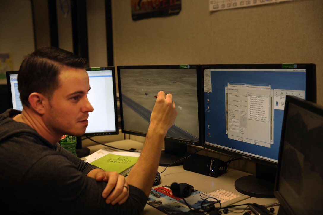 Ryan Brown, field service representative, Combat Convoy Simulator, controls part of the simulated scenario at Camp Wilson, Feb. 11, 2015. The simulation was comprised of a combination the CCS and the Deployable Virtual Training Environment to which the entire company to work together in real time. (Official Marine Corps photo by Lance Cpl. Thomas Mudd/ Released)