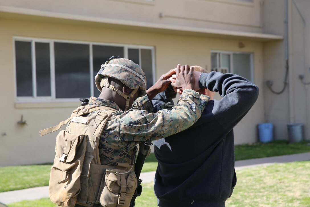 Marine with captured "protester" during Special Marine Air Ground Task Force embassy reinforcement exercise, Marine Corps Logistics Base Barstow, Calif.,Feb.10.