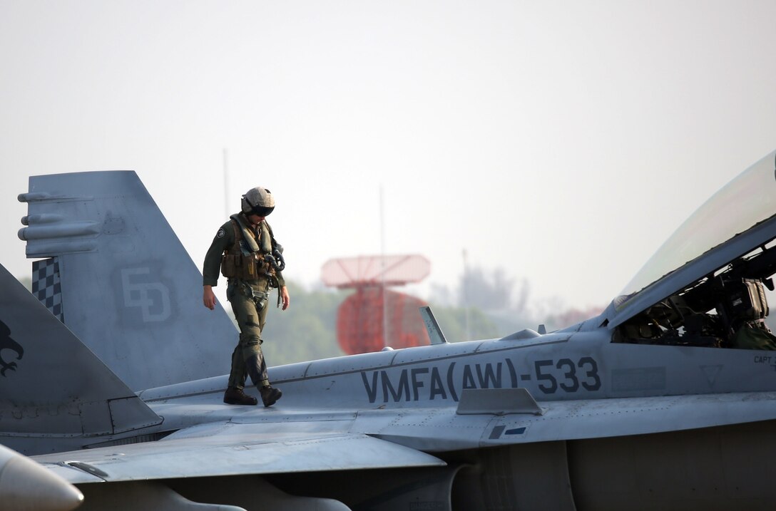 A U.S. Marine pilot inspects his F/A-18 Hornet prior to take off, Feb. 16.  U.S. Marines attached to Marine Aircraft Group 12, 1st Marine Aircraft Wing, III Marine Expeditionary Force, and the Royal Thai Air Force train bi-laterally to maintain readiness and interoperability in support of peace and security in the region as part of Exercise Cobra Gold 2015. For more information on exercise Cobra Gold, please visit the official Facebook page at http://www.facebook.com/ExerciseCobraGold.  