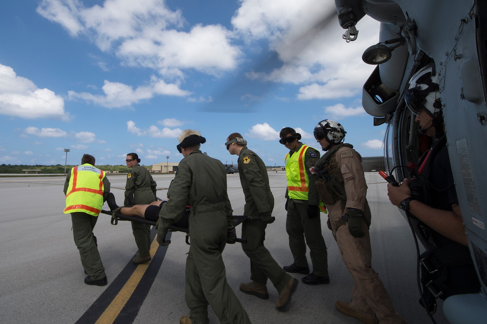 Aeromedical personnel from the U.S. Air Force and Royal Australian Air Force, transfer a simulated downed pilot from a U.S. Navy MH-60S Knighthawk during a multinational search and rescue exercise at Cope North 15, Feb. 18, 2015, at Anderson Air Force Base, Guam. Exercise Cope North 15 enhances humanitarian assistance and disaster relief crisis response capabilities between six nations and lays the foundation for regional cooperation expansion during real-world contingencies in the Asia-Pacific Region. (U.S. Air Force photo by Tech. Sgt. Jason Robertson/Released)