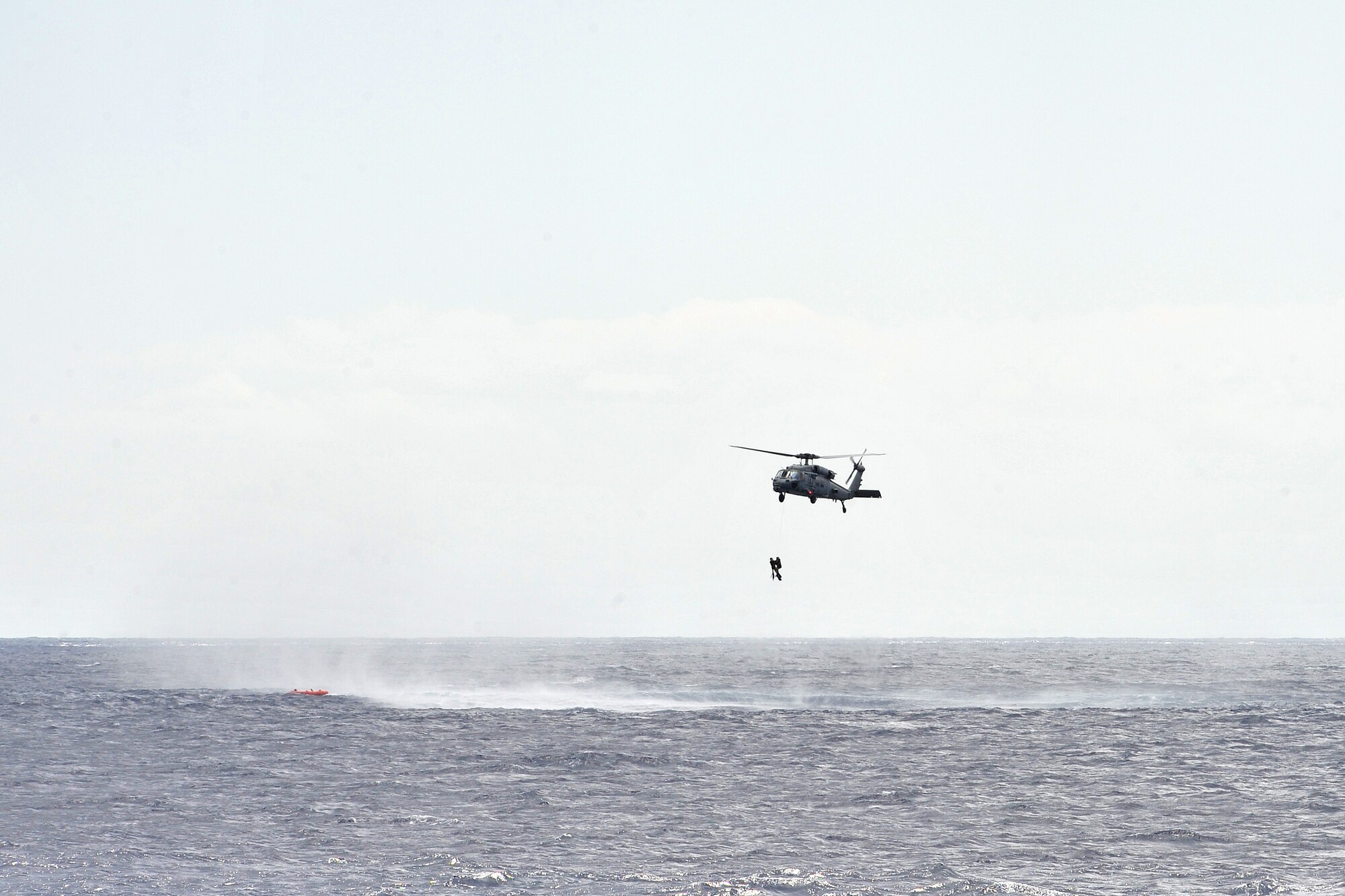 U.S. Navy Helicopter Sea Combat Squadron 25 members conduct a search and rescue mission off the coast of Guam Feb. 18, 2015. Exercise Cope North 15 enhances humanitarian assistance and disaster relief crisis response capabilities between six nations and lays the foundation for regional cooperation expansion during real-world contingencies in the Asia-Pacific Region. (U.S. Air Force photo by Staff Sgt. Melissa B. White/Released)