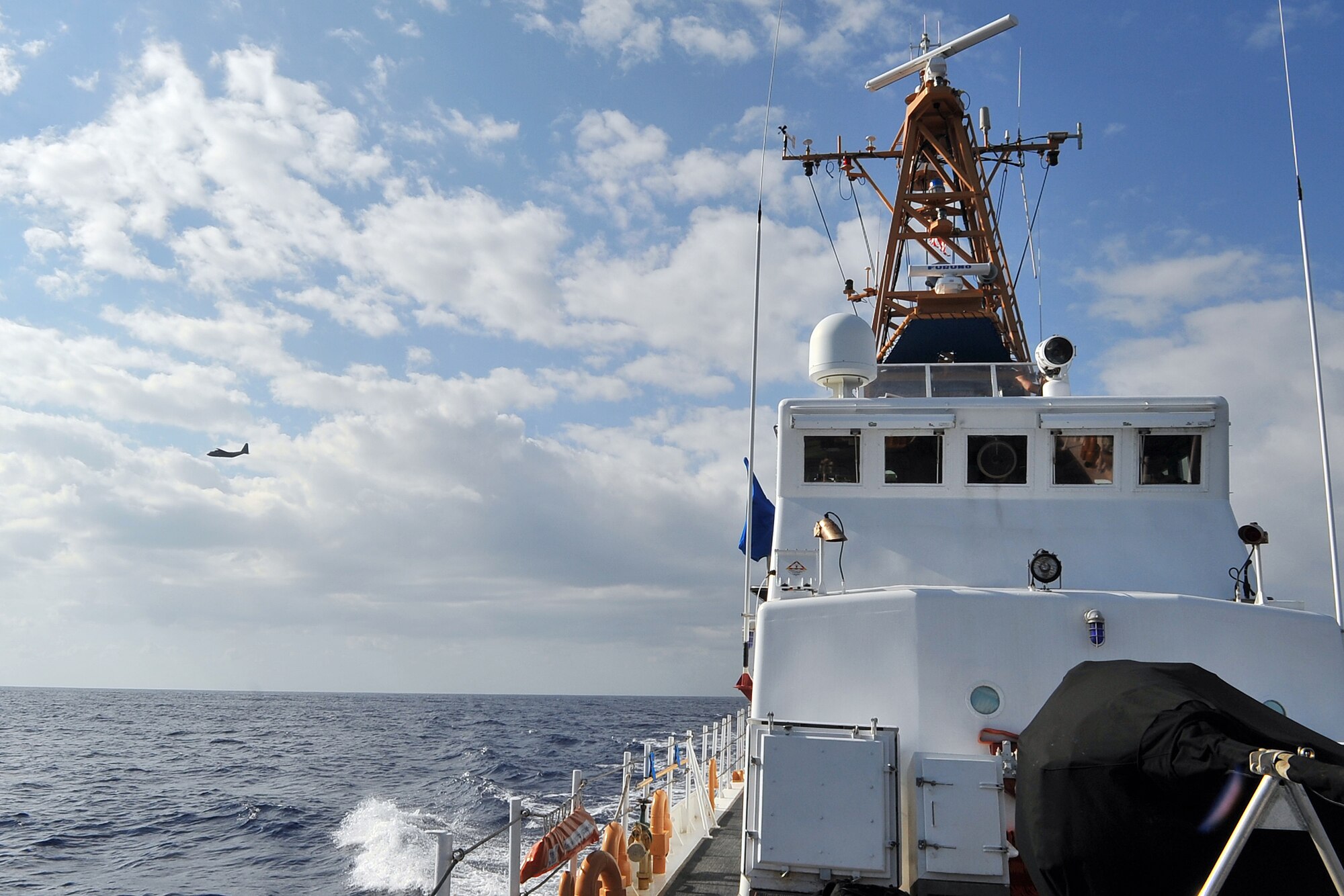 A C-130 Hercules aircrew flies over the U.S. Coast Guard Cutter Washington off the coast of Guam Feb. 18, 2015, during a search and rescue exercise. Exercise Cope North 15 enhances humanitarian assistance and disaster relief crisis response capabilities between six nations and lays the foundation for regional cooperation expansion during real-world contingencies in the Asia-Pacific Region. (U.S. Air Force photo by Staff Sgt. Melissa B. White/Released)