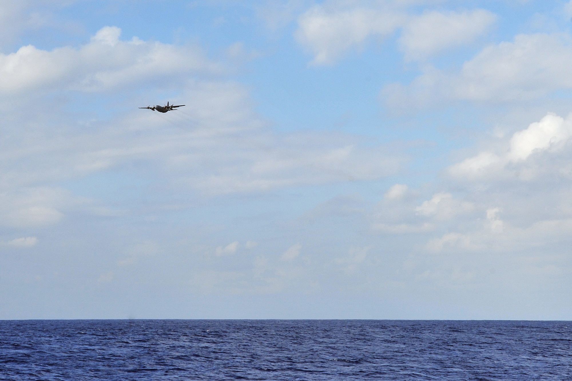 A U.S. Air Force C-130 Hercules aircrew flies over the coast of Guam Feb. 18, 2015, during a search and rescue exercise. Exercise Cope North 15 enhances humanitarian assistance and disaster relief crisis response capabilities between six nations and lays the foundation for regional cooperation expansion during real-world contingencies in the Asia-Pacific Region. (U.S. Air Force photo by Staff Sgt. Melissa B. White/Released)