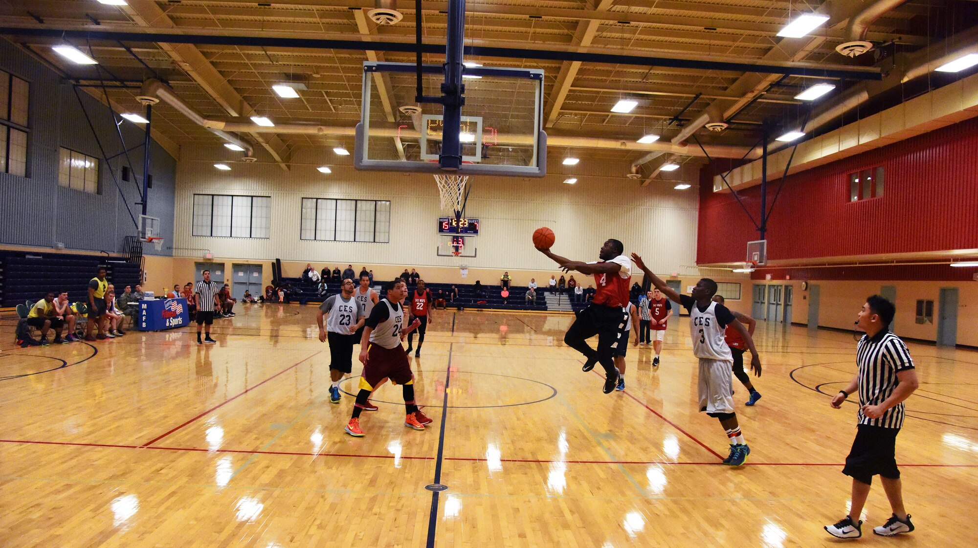 Senior Airman Darius Gordon, 741st Missile Security Forces Squadron convoy response force team leader (center), attempts to score during the 2015 Intramural Basketball Championship Game at Malmstrom Air Force Base’s Fitness Center Feb. 18. This season, more than 200 Airmen participated in Malmstrom’s intramural basketball league. (U.S. Air Force Photo/Airman 1st Class Collin Schmidt)