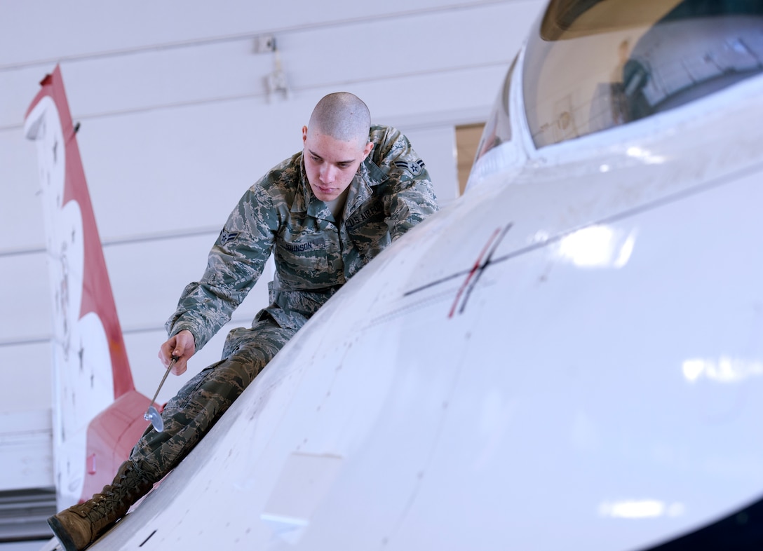 Airman 1st Class Jeremy Johnson, 362nd Training Squadron Aerospace Maintenance Course student, performs a maintenance inspection on a Thunderbird F-16 Fighting Falcon trainer Feb. 12, 2015 at Sheppard Air Force Base, Texas. Students train to inspect for faults and damages and make necessary repairs before the aircraft is ready to fly.  (U.S. Air Force Photo Danny Webb)
