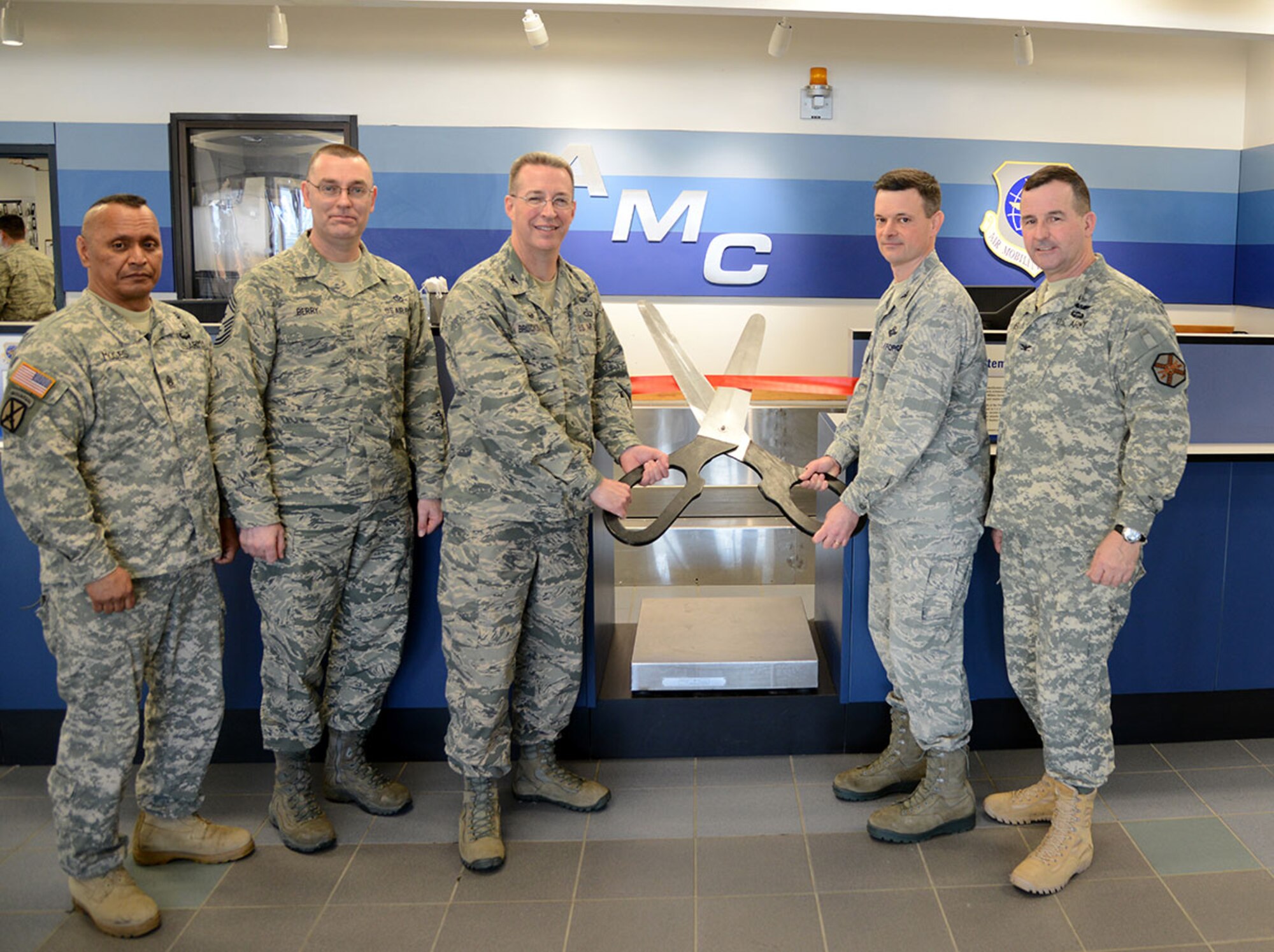 Senior Joint Base Elmendorf-Richardson leadership cut a ribbon as part of reopening ceremonies for the JBER Air Passenger Terminal Feb. 13. The PAX terminal recently underwent $2.8 million worth of renovations designed to strengthen the building’s structural integrity, increase efficiency, decrease operating costs and improve passenger comfortability. (U.S. Air Force photo/Staff Sgt. Wes Wright)